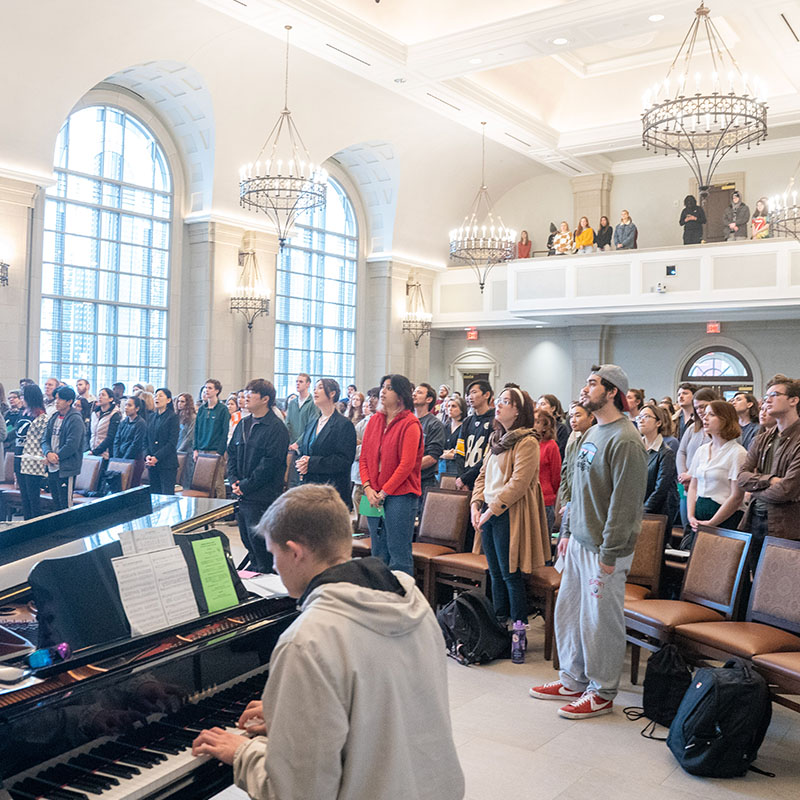 A student playing a piano in the Gabhart Chapel