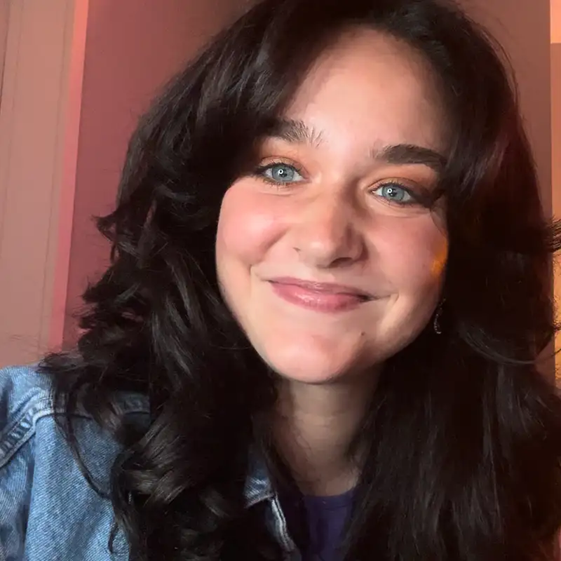 A female student smiling with pursed lips