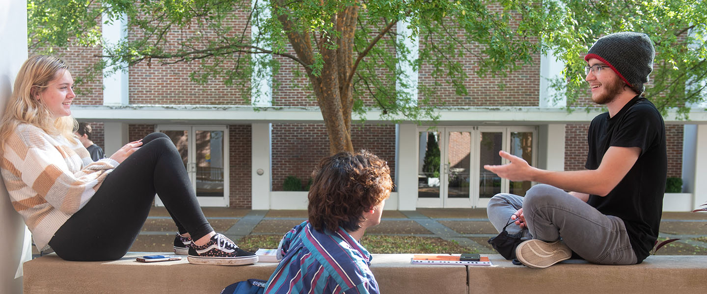 A student walking across campus in the fall