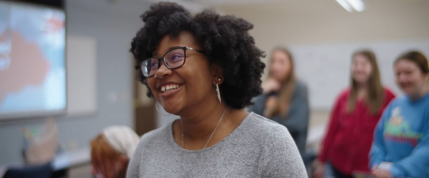 A female student smiles in class