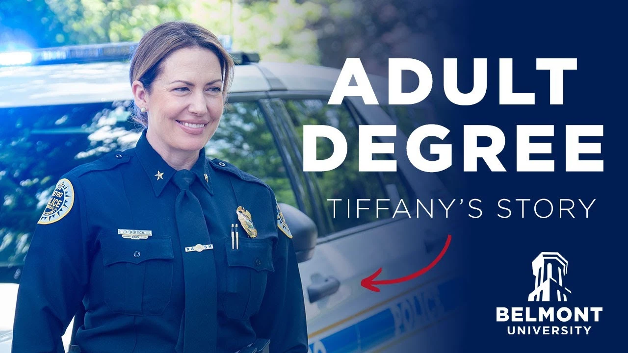 Tiffany, a smiling female police officer in blue uniform with badges standing in front of a police vehicle. Text reads "Adult Degree - Tiffany's Story" with Belmont University logo