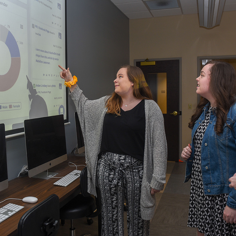 adult students presenting in class at a whiteboard