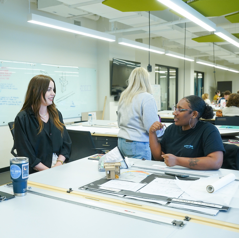 Students having group discussion in an architecture classroom