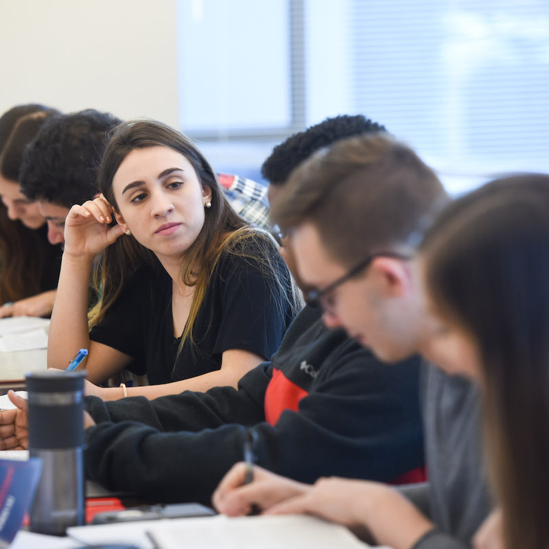 Students speak in classroom small groups during class 