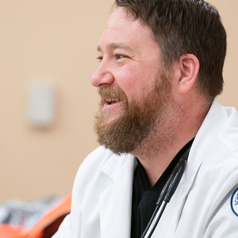 A graduate nursing student smiling during class