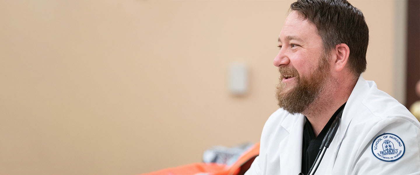 A nursing student smiling during a class discussion