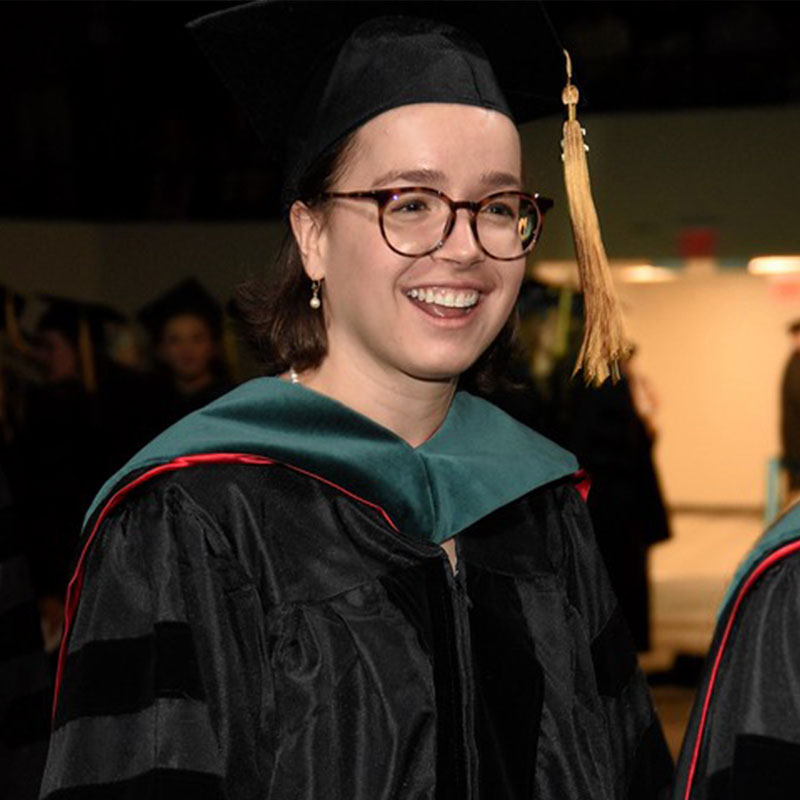 A graduating DPT student in her graduation robes