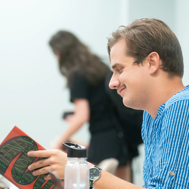 Student reading book in class