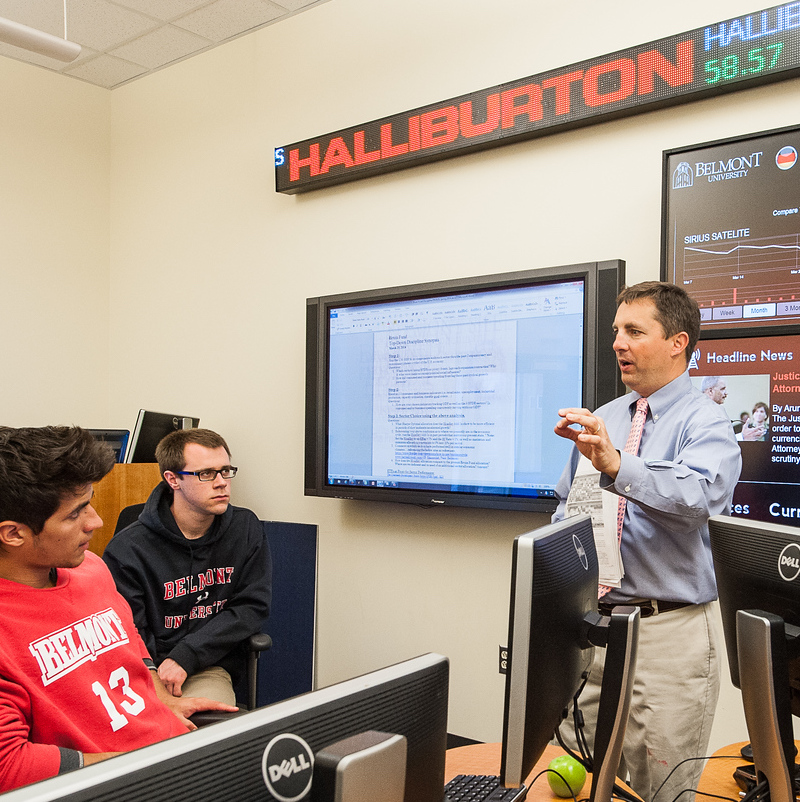 Students listening to professor lecture in computer lab