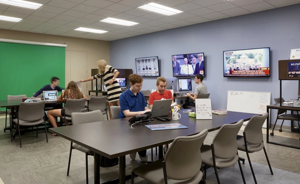 Students working in journalism student newspaper office. 