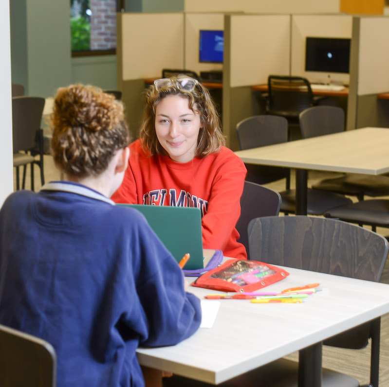 Two students working on a group project in a classroom