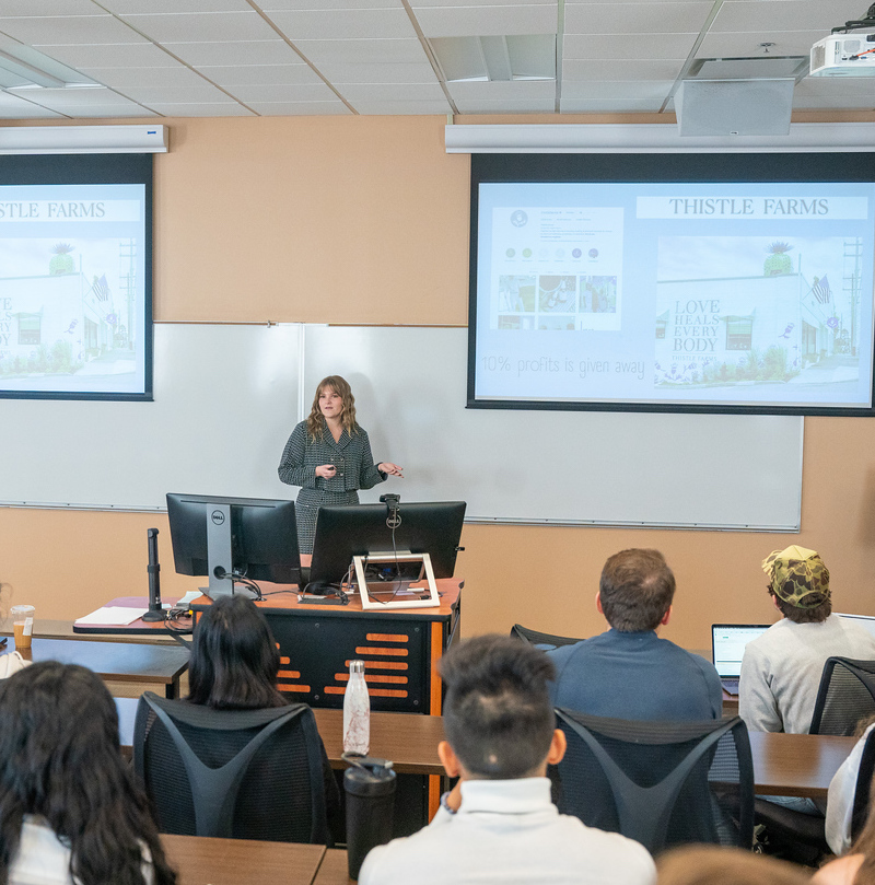 Students in a class room learning from a student presenter