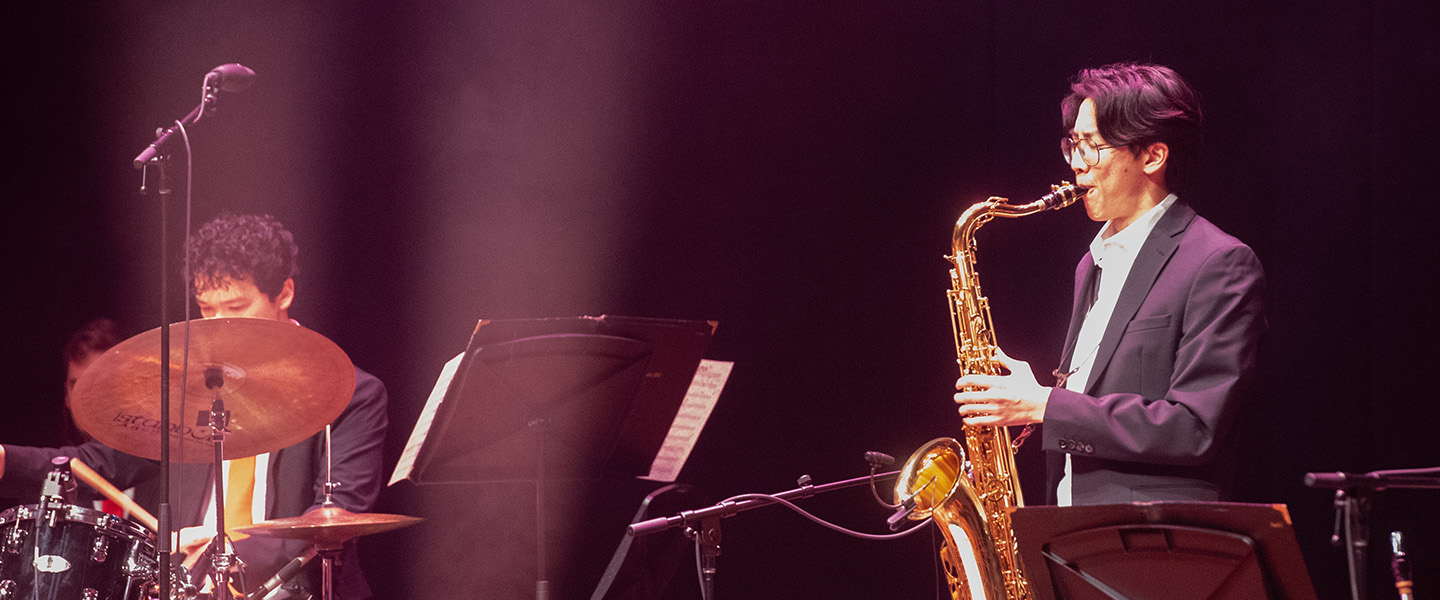 A male student plays the saxophone.