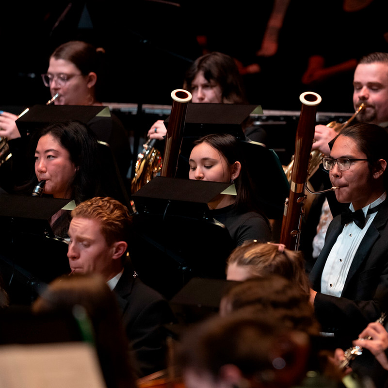 Students playing woodwinds in an concert setting