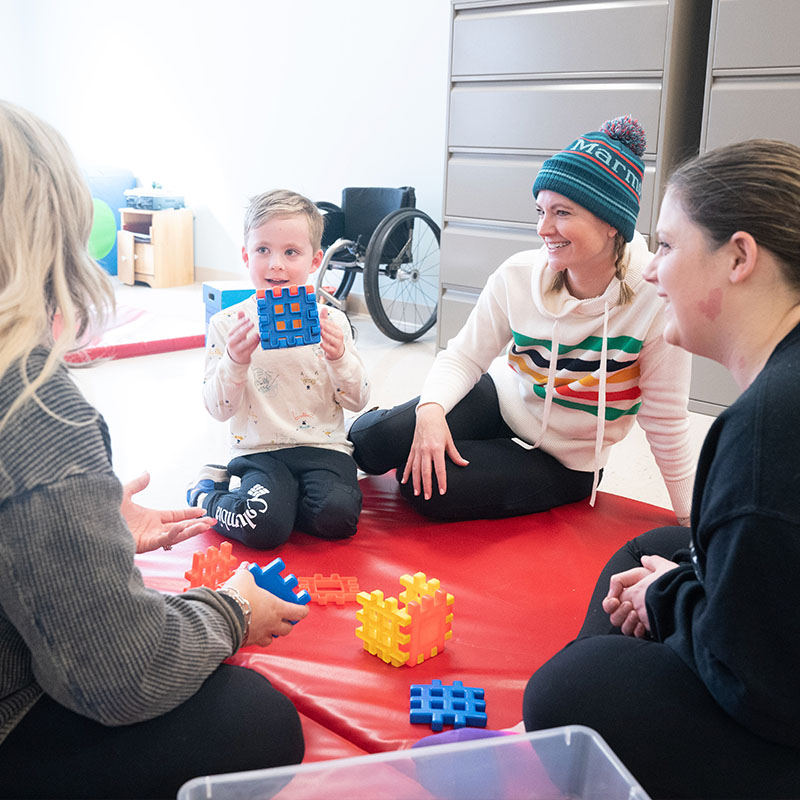 Three OT students working with a child