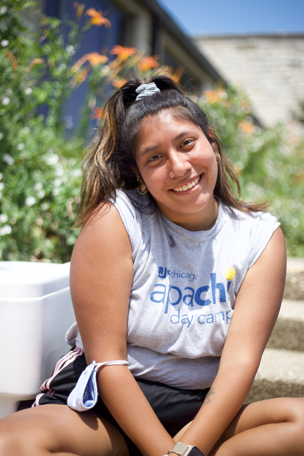 Photographic studies student Becca Pollak sits in front of plants