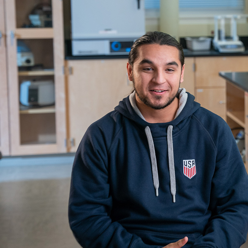 student Alec Khatter sitting in science lab