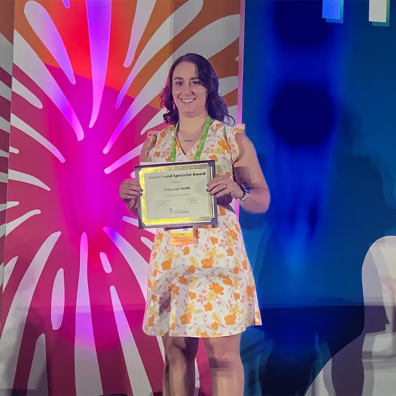 Indoor photo of Sheyanne Smith holding an award