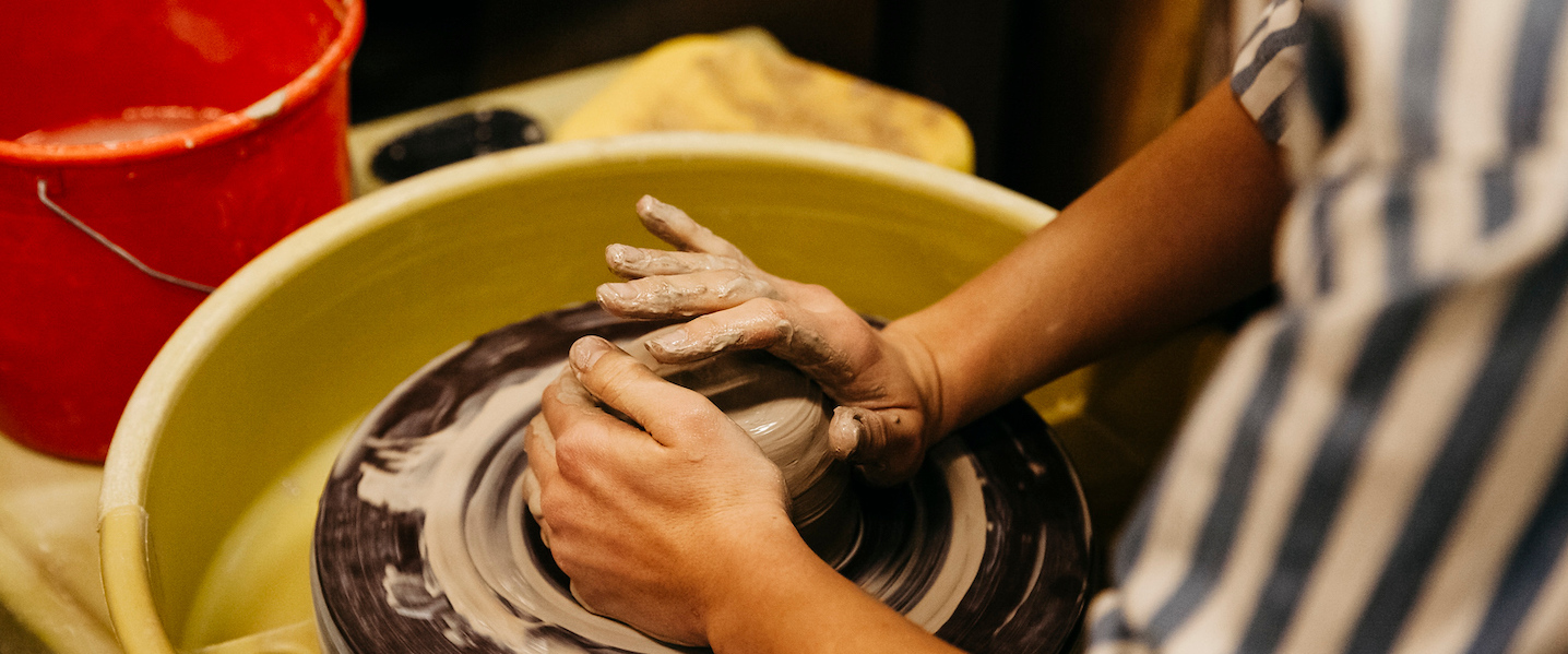 Watkins student works with clay to create a dish