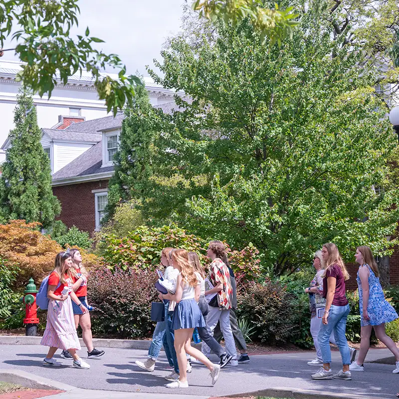 Student Tour guides leading a tour group across campus