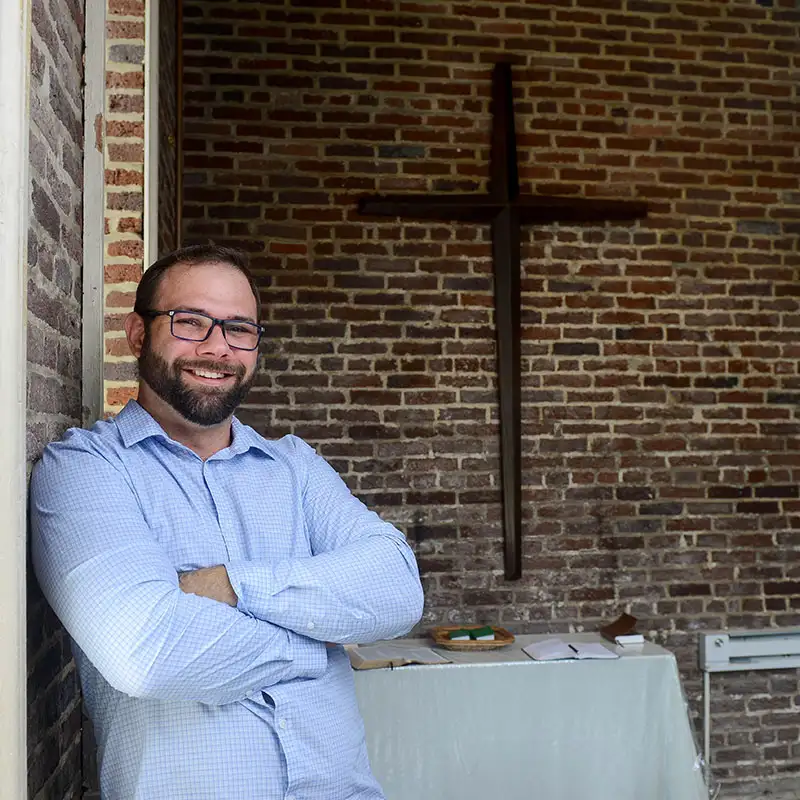 Adult Student standing in Belmont's Bell Tower Chapel