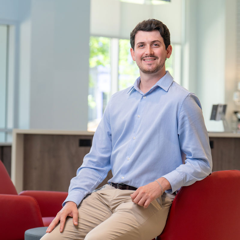 male adult degree student sitting in chair