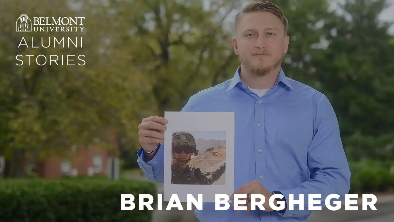 A male Veteran holding an image of himself and where he served