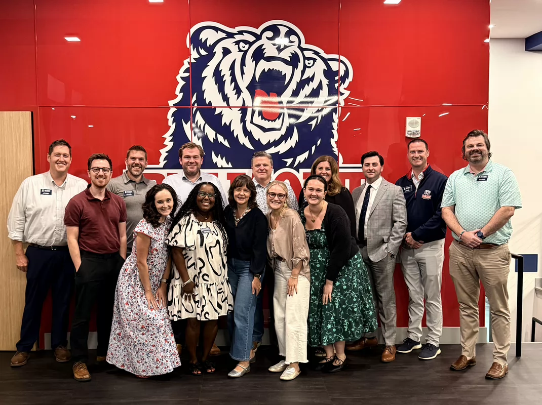 The 2025-2026 Alumni Board smiles for a photo in the Vince Gill Room on campus.