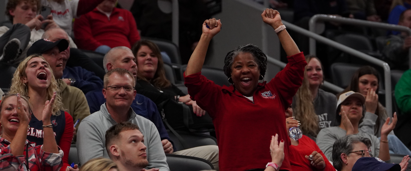 Belmont fans cheer in the bleachers during a basketball game.