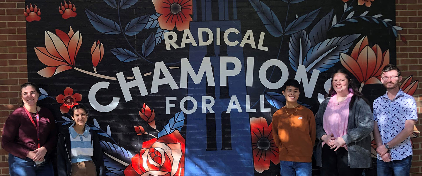 Peer Career Advisors stand in front of the Radical Champions Mural