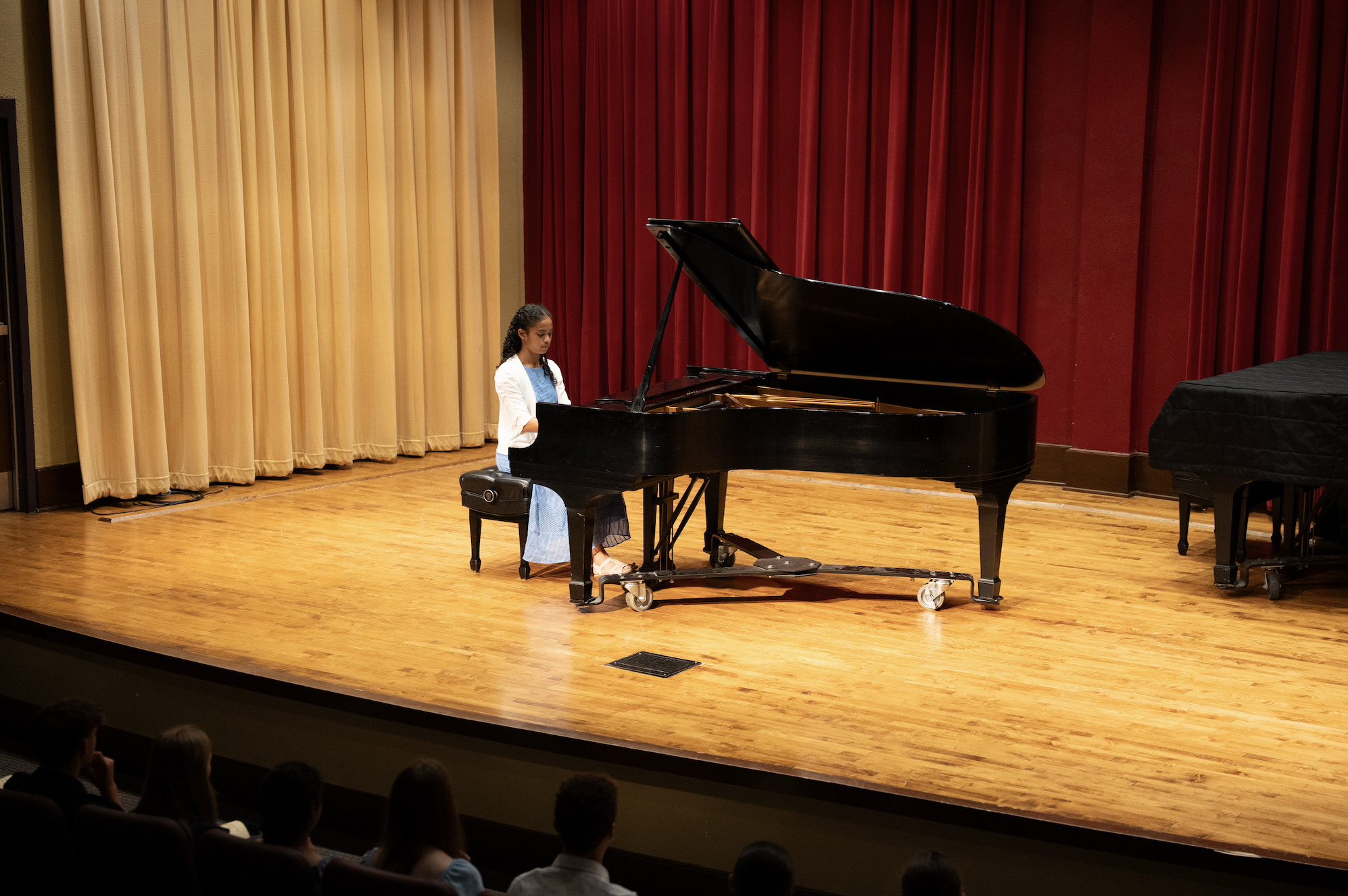 Summer camp students participate in piano class