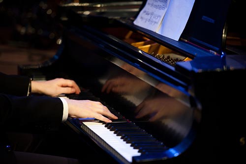 close up of piano ensemble member playing the piano