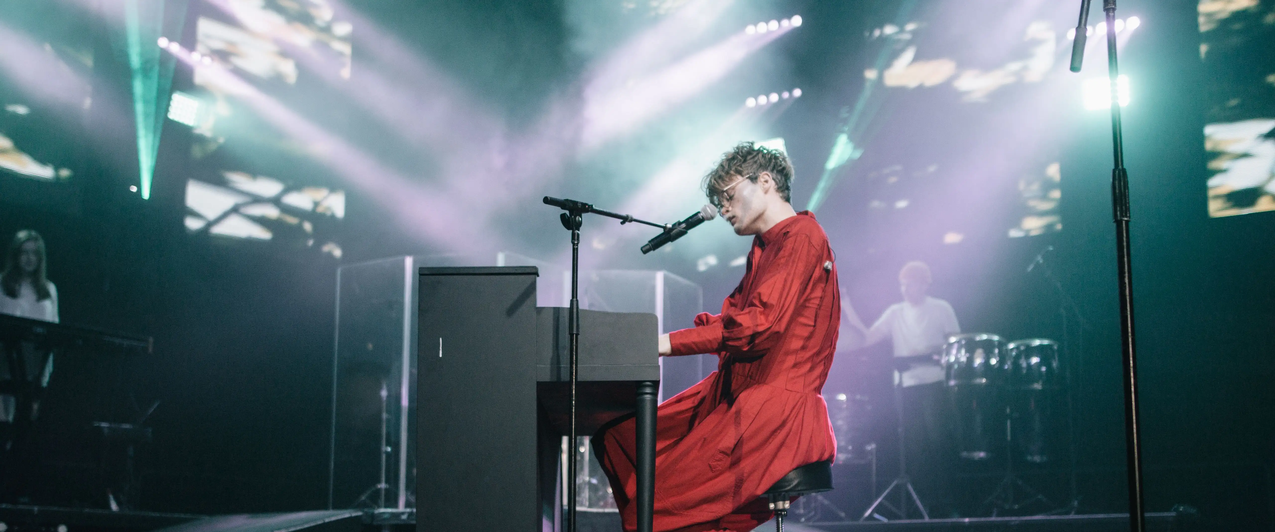 Jake Wesley Rogers performing on a piano on an a arena concert stage