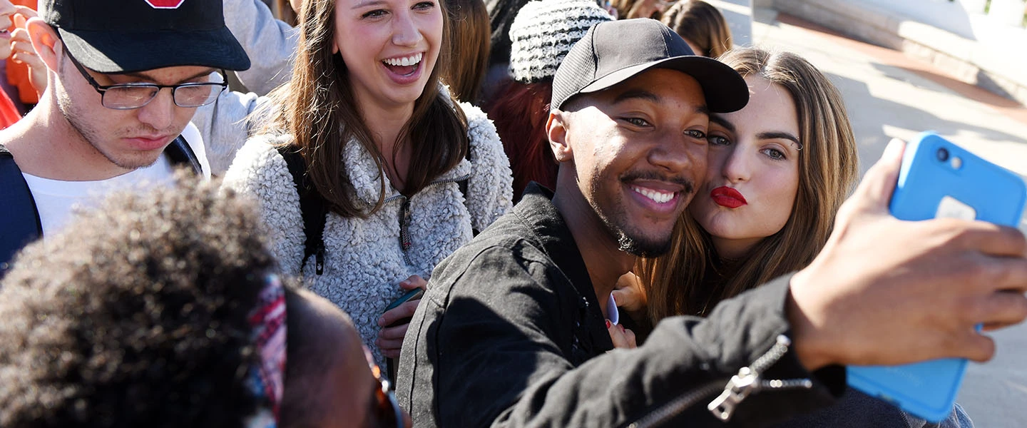 Students taking a selfie with pop music artist JoJo