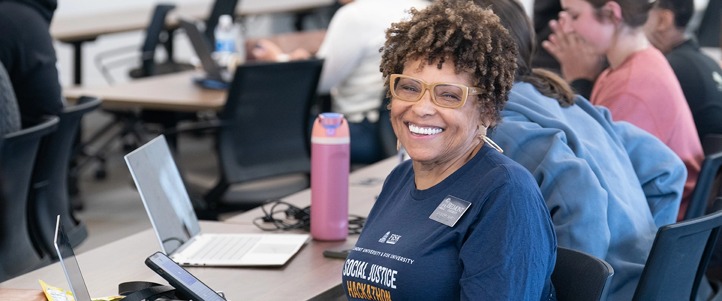 A woman smiling at the camera at the Fisk-Belmont Social Justice Data Hackathon at Belmont University