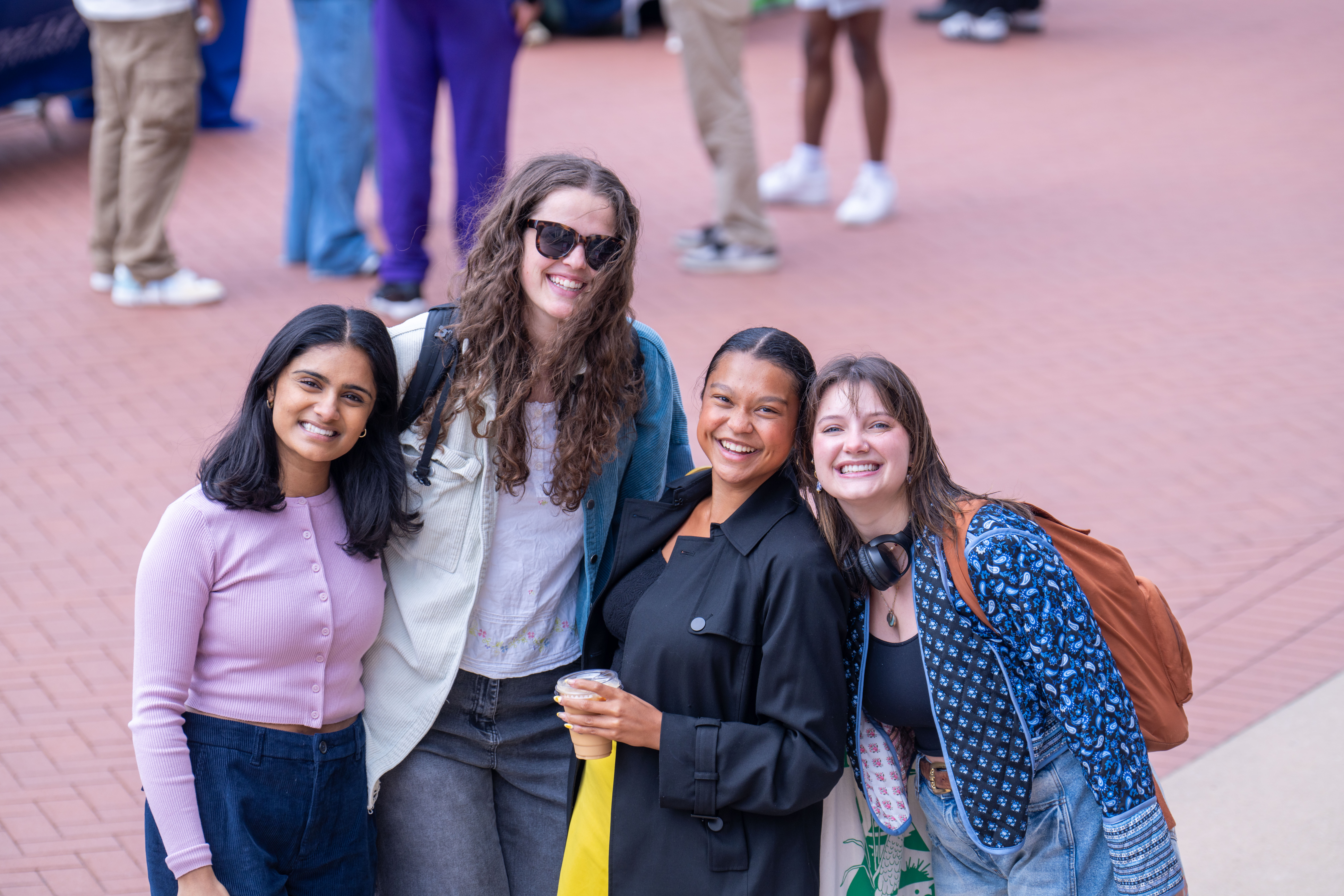 Four students standing in Freedom Plaza at It Must Be Wednesday