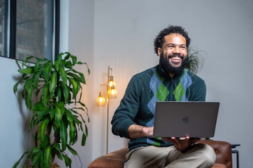 Executive Education student studying onlaptop in his home.