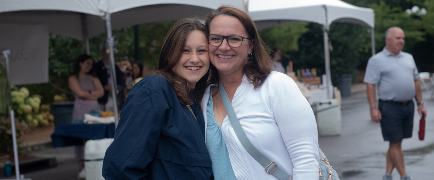 Associate Vice President for Engagement, Kate Mosley, talks with a parent at a Parent Leadership Circle event.