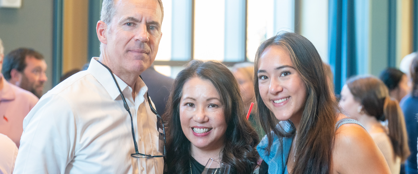 A mother, father and daughter smile for a picture at a Parent Leadership Circle event.