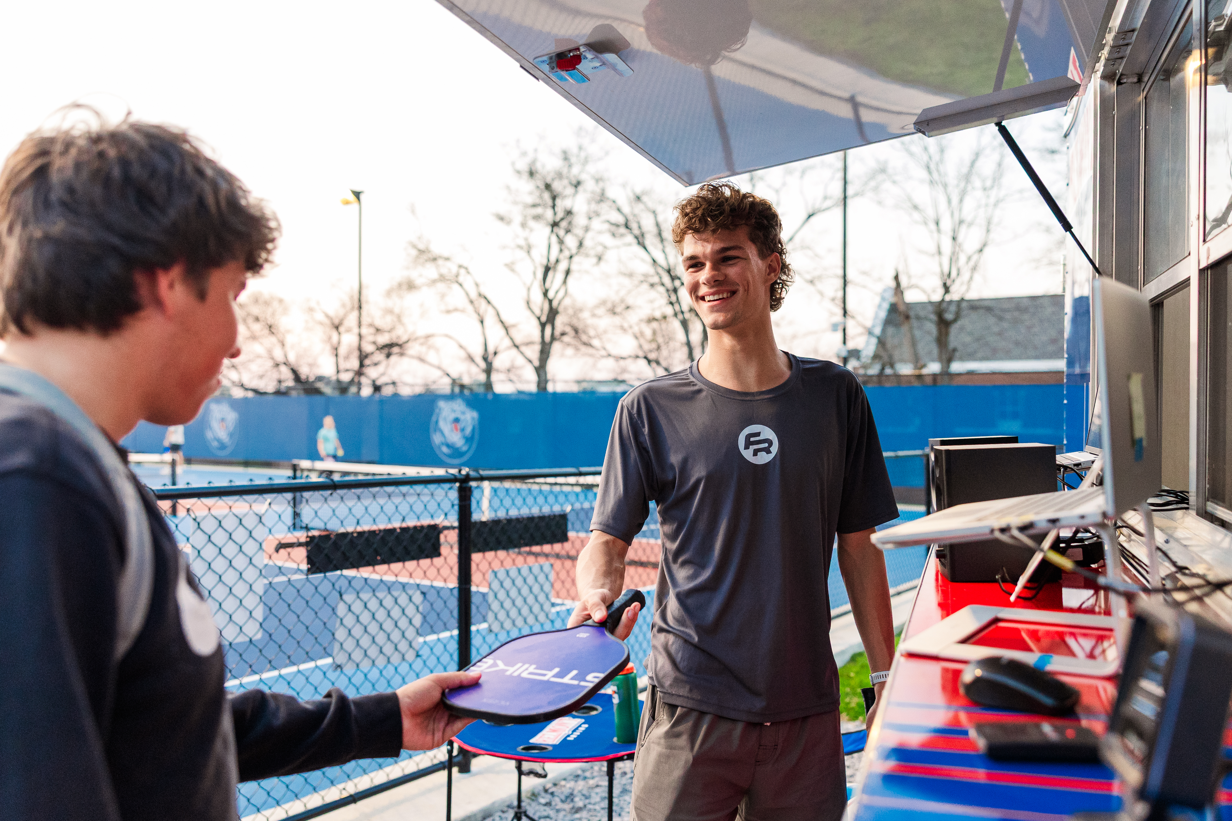 An employee working at the Pickleball and Beach Volleyball courts