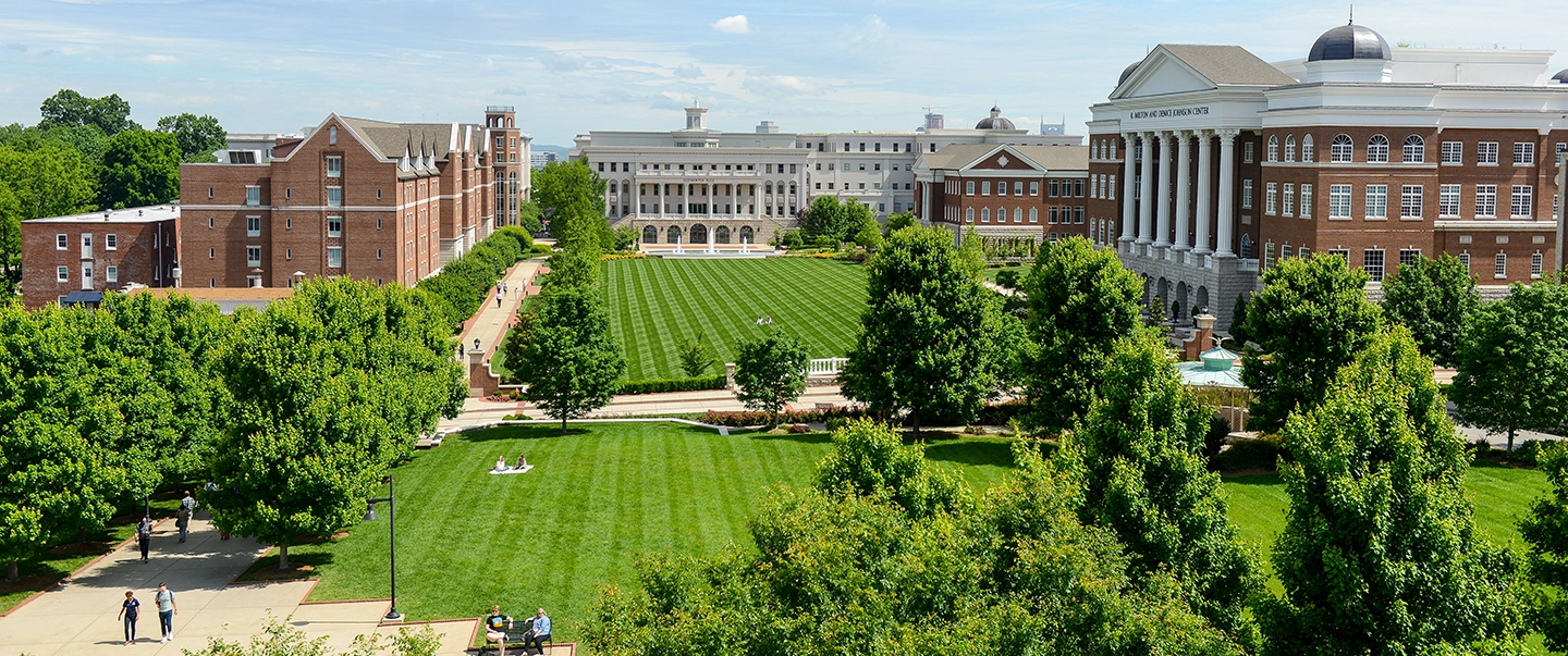 Arial photo of the Belmont lawn and buildings with people on blankets enjoying the outdoors.