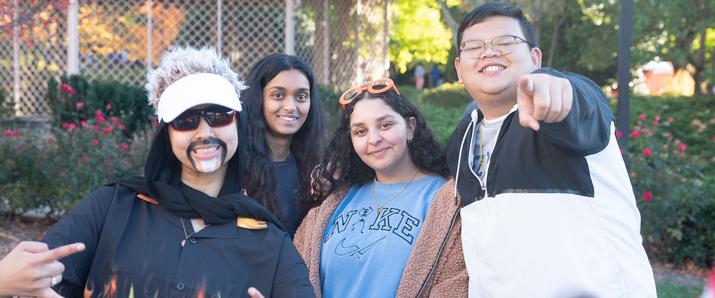 4 students smiling at the camera during Belmont's Fall Festival