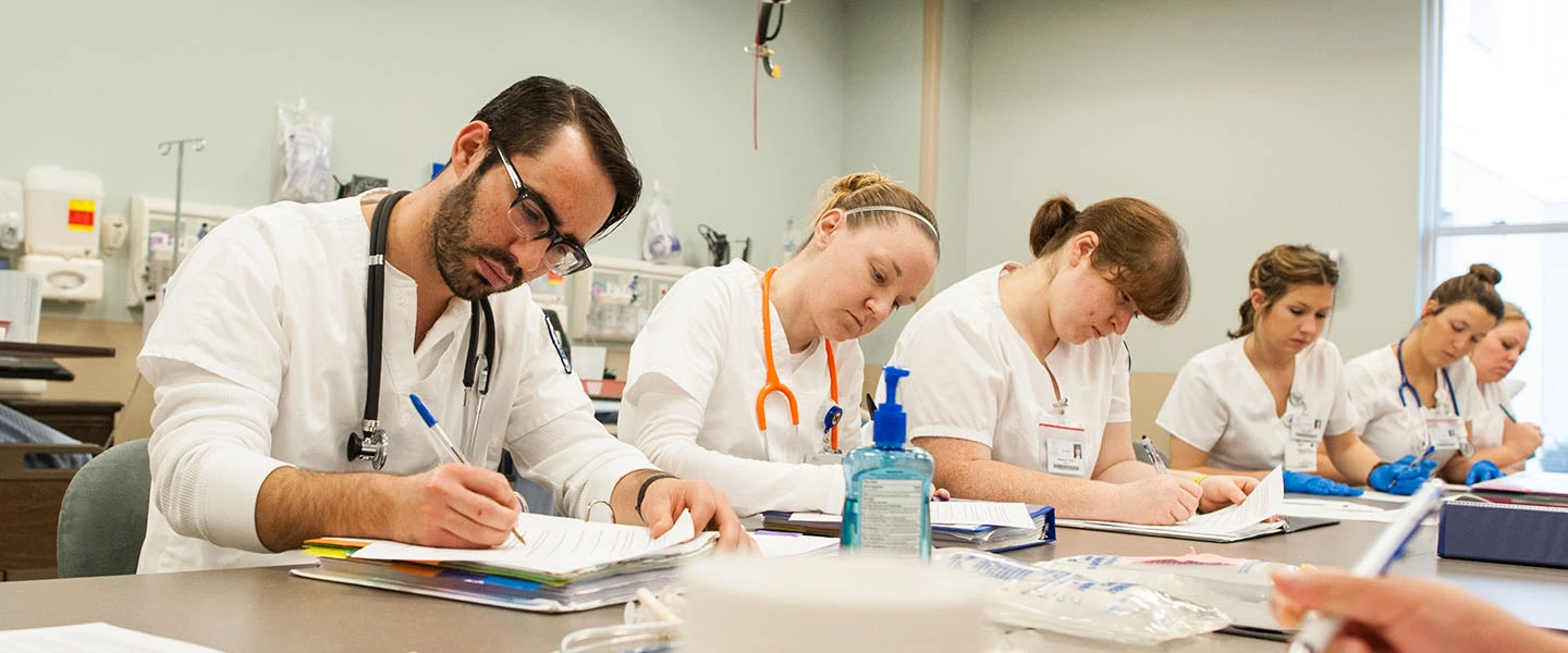 Nursing students working on a quiz while in class.