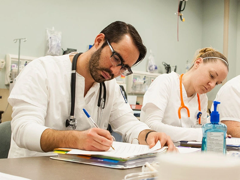 Nursing students working on a quiz while in class.