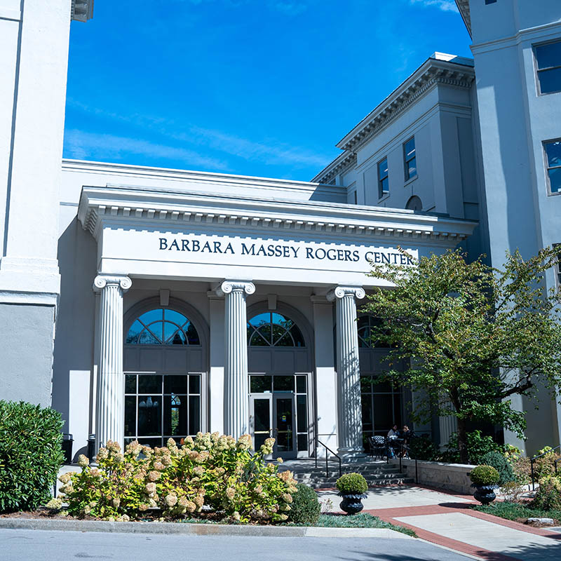 Outside of the campus facing Barbra Maseey Rogers Center building on a sunny day