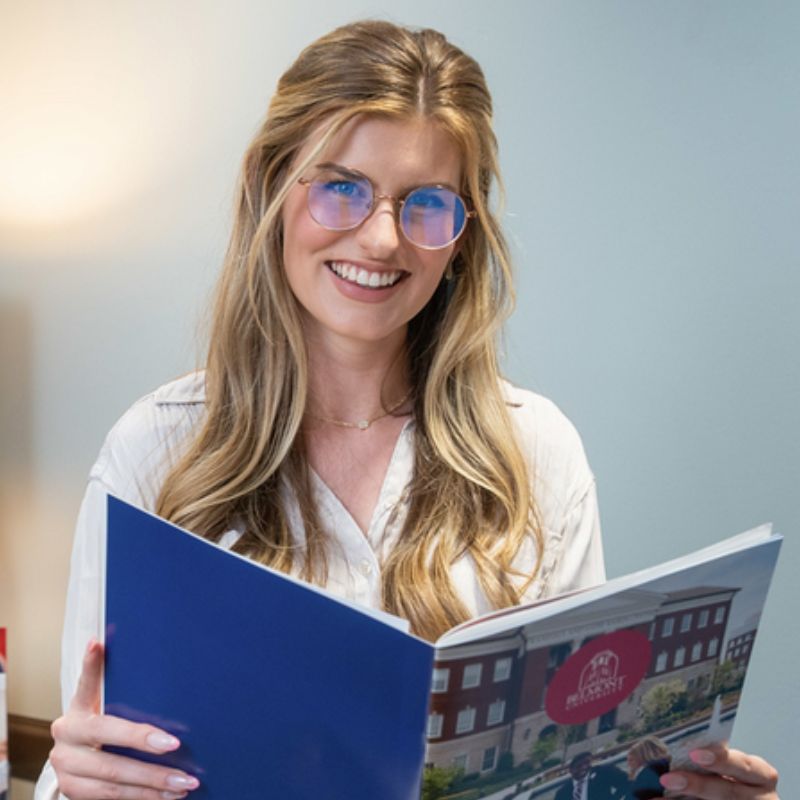 Student holding admissions packet