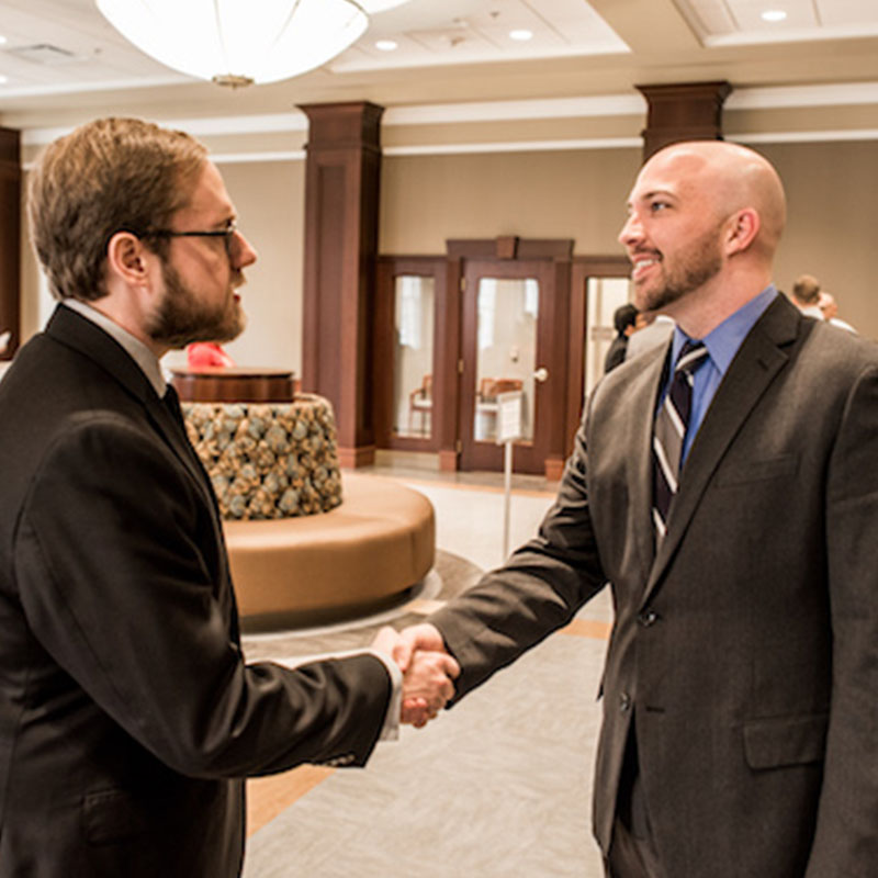 Employer shaking hands with student