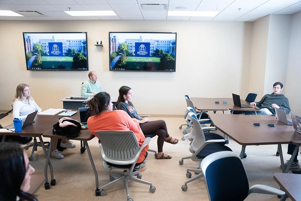 Massey classroom with students listening to professor and class discussion