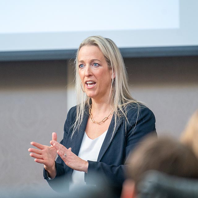 Teacher speaking at ethics discussion in conference room