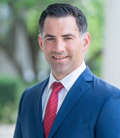 A portrait of a man in a suit and tie.